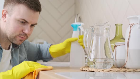 Man in Protective Gloves Cleaning Kitchen