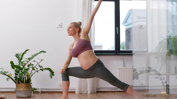 Happy Pregnant Woman Doing Yoga at Home