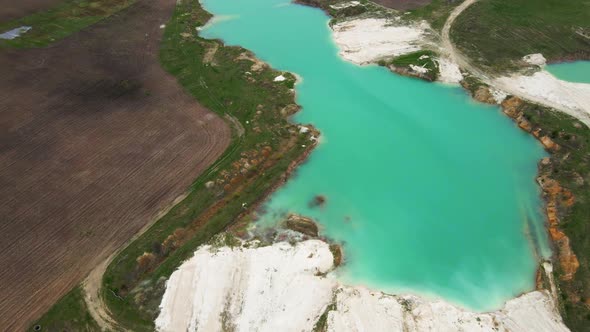 Aerial drone view Amazing industrial landscape, on Emerald lake in a flooded quarry