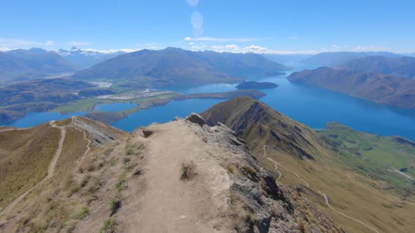 Walk along the edge of Roys Peak train with stunning Lake Wanaka in the background, Point of view wi