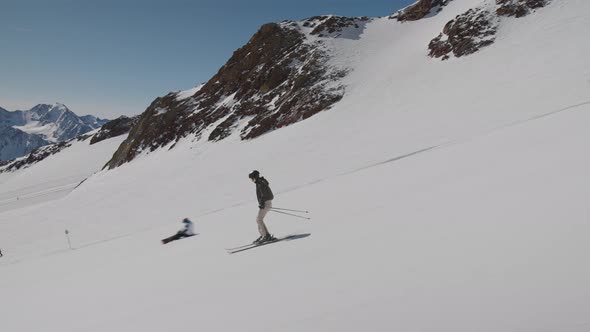 Woman Skiing Quickly Down Mountain Ski Slope