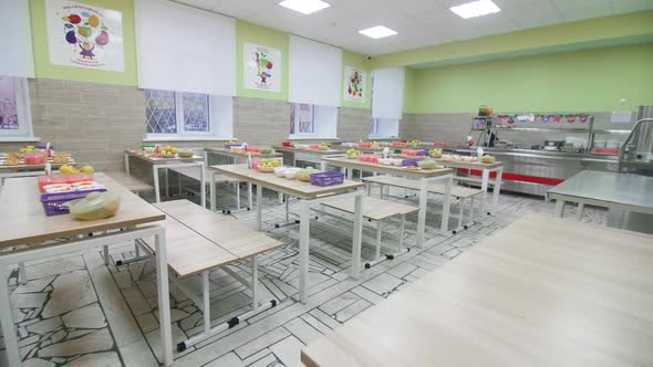 Tables with Healthy Food and Drinks in School Canteen