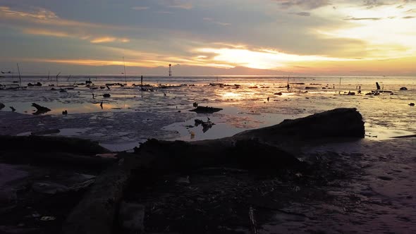 Silhouette sliding over the rubbish tray thrown at the coastal