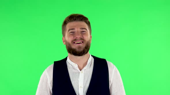 Man Laughs While Looking at Camera. Green Screen