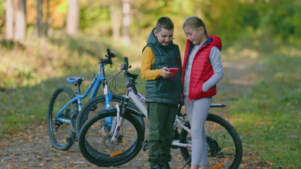 Children Look at the Phone While in Nature