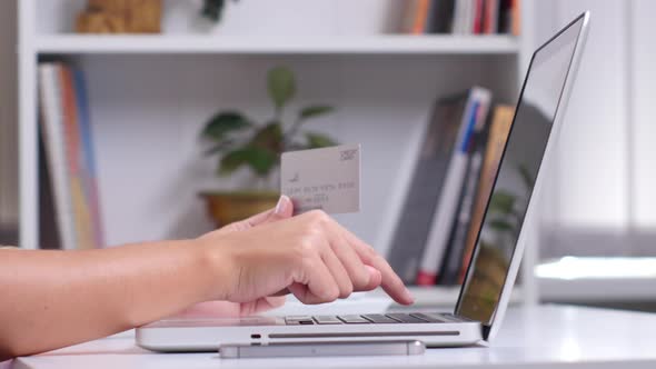 Woman Hands Holding a Silver Credit Card and Using Smart Phone for Online Shopping. Close Up