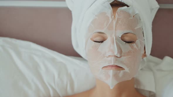 Woman with Cosmetic Mask on Face