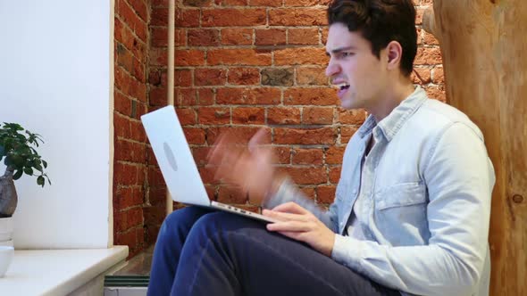 Angry Frustrated Young Man Working on Laptop