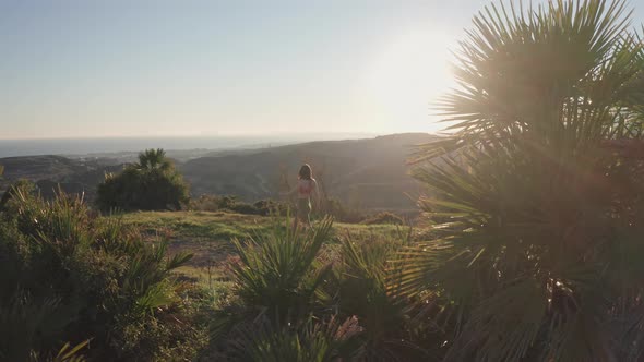 Woman Jogging To Halt To Look At Sunset