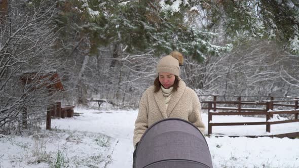 Woman in the forest with baby carriage