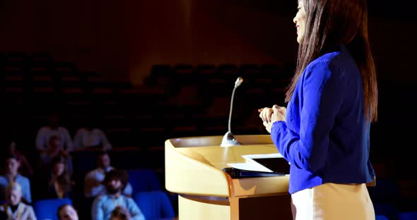 Young mixed-race businesswoman speaking in business seminar at auditorium 4k