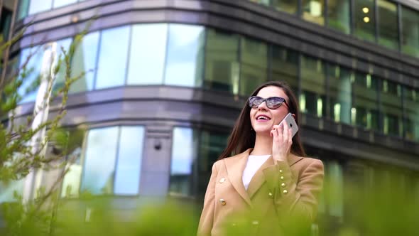 Close-up Portrait of a Woman, Walking Around the City Against the Background of a European Office