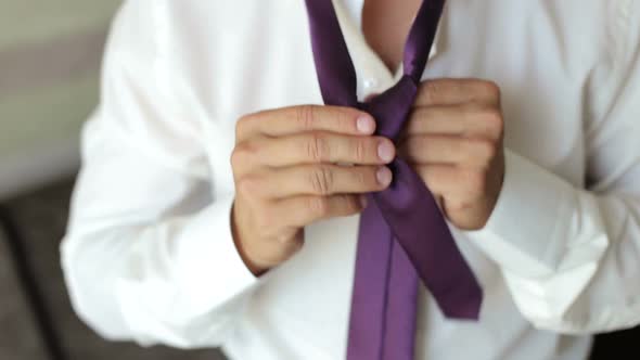 Man in White Shirt Tying the Necktie Closeup