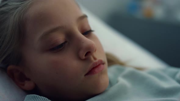 Closeup Sick Girl Lying in Hospital Bed Alone