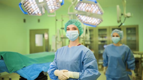 Two Happy Female Doctors in Medical Face Masks, Gloves and Caps