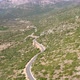 Aerial view car travels едет по дороге in beautiful mountainous terrain. - VideoHive Item for Sale