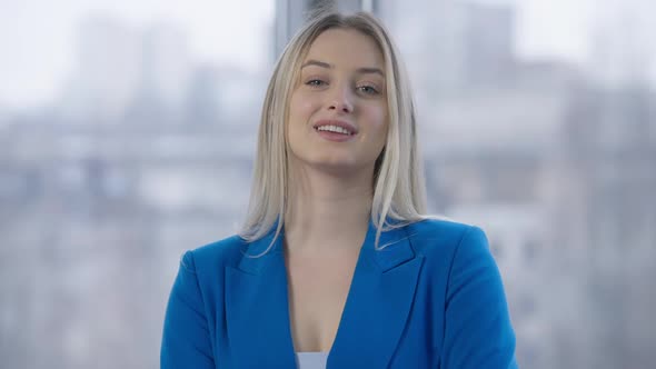 Portrait of Charming Confident Slim Woman Crossing Hands Looking at Camera and Smiling