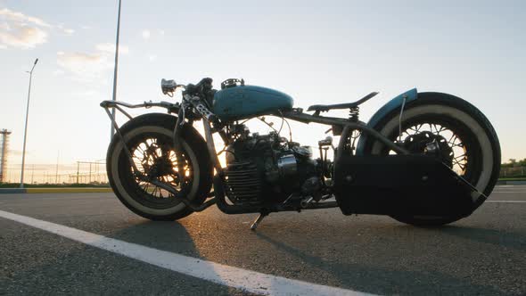 Closeup Dolly Shot of Custom Cafe Racer Motorcycle at Sunset on Street