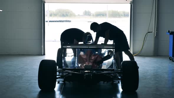 Maintenance Specialists are Working on a Racing Car