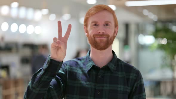 Portrait of Beard Redhead Man with Victory Sign By Hand 