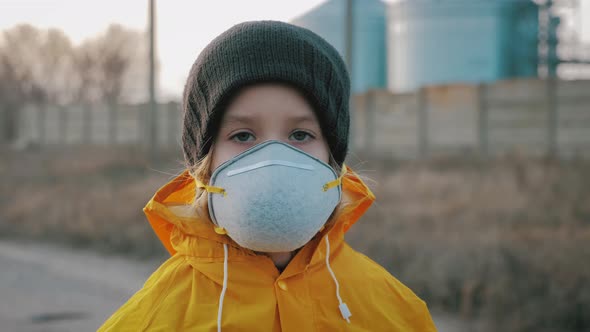 Child Girl in Protective Mask on Industrial Plant Smoke Background. Atmospheric Pollution and People