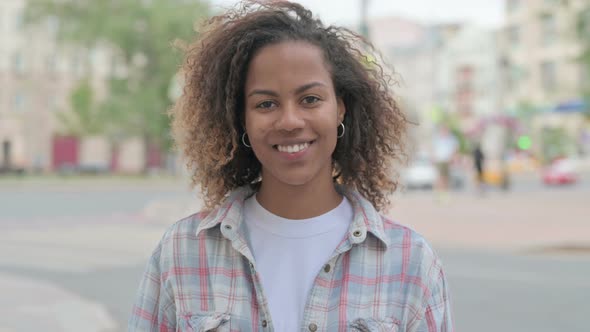 Portrait of African Woman Smiling at Camera Outdoor