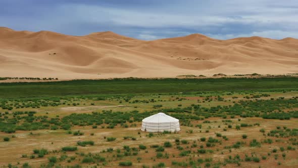 Aerial Around View on Yurt Near Sand Dunes