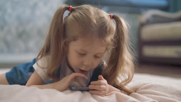 Low Angle Shot Little Girl Lies in Room