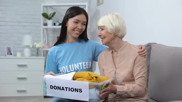 Happy Female Volunteer and Aged Woman Holding Donation Box, Humanitarian Aid