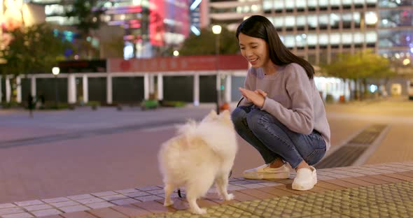 Woman train her dog in city