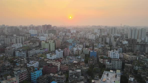 Drone flight over polluted city of Dhaka, sunset with smoggy horizon