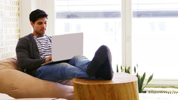 Business executive using laptop in office