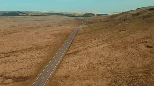 Abstract aerial view of Empty country road between brown dried up field