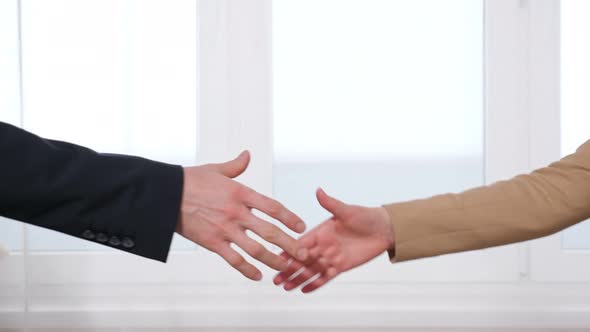 Man and Woman Shake Hands Giving Over Keys to Apartment