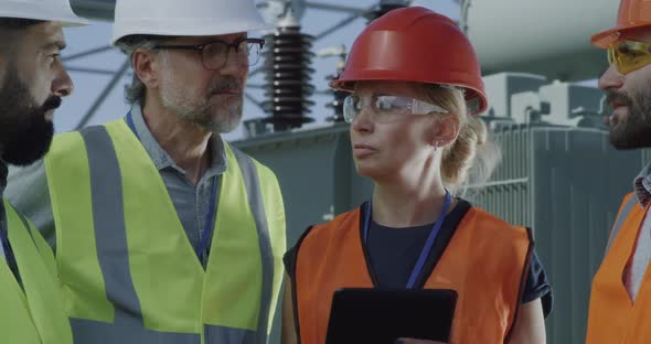 Mature Engineer Talking on Smartphone During Meeting on Power Station