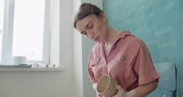 Female Potter Sitting and Makes a Cup. Woman Making Ceramic Item. Pottery Working, Handmade and