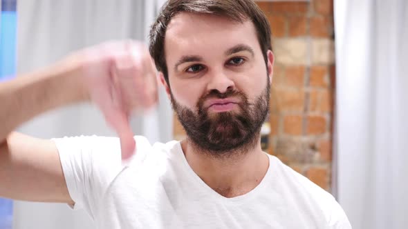 Beard Man Gesturing Thumbs Down Indoor