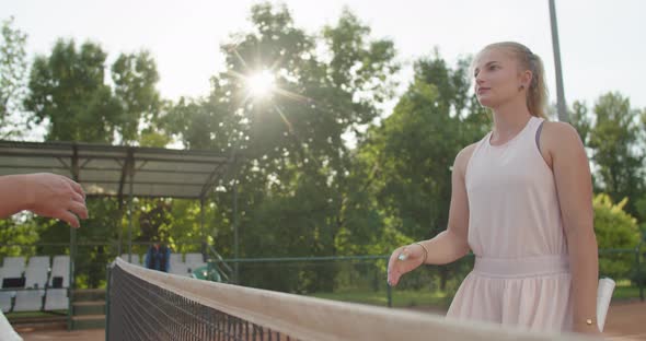 Low Angle Crop View of Two Women Greeting Each Other Before Tennis Match Competition