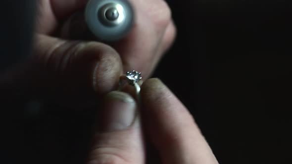 Closeup of Wedding Ring Polishing By Caicasian Jeweler Isolated  Footage