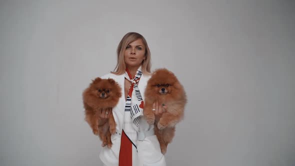 Fashionable Girl with Scarf Holding a Chihuahua Dog in Her Arms