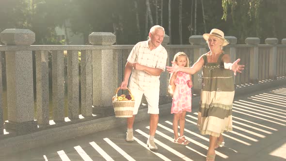 Granddaughter and Grandparents Having Fun Outdoors.