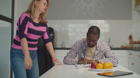 Diverse Loving Couple Relaxing in Domestic Kitchen