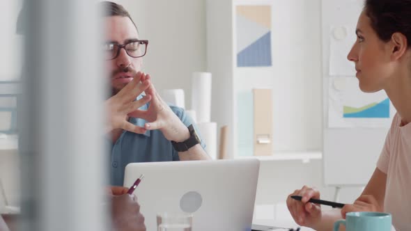 Three Colleagues Talking in Office