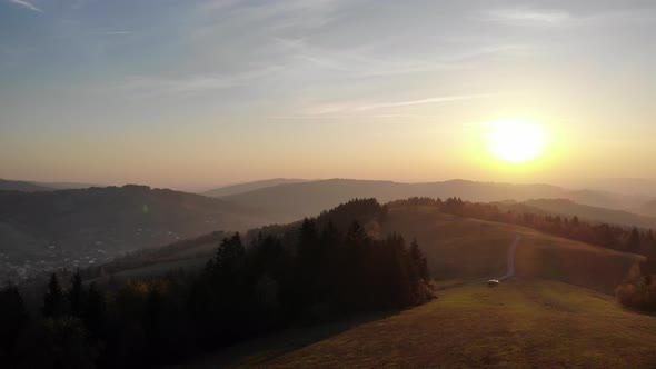 Flight over autumn mountains in the light of the setting sun.