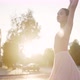 Elegant Ballerina Jumps and Spins on Street Against Sunlight - VideoHive Item for Sale
