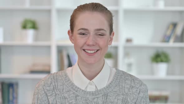 Portrait of Smiling Young Woman Looking at Camera