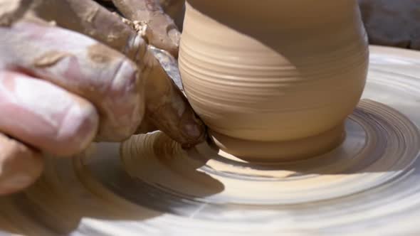 Potter's Hands Work with Clay on a Potter's Wheel