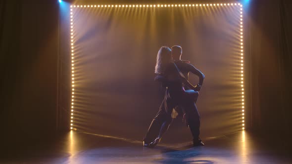 A Young Woman in a Chic Short Black Dress Is Dancing Rumba with Her Partner. Silhouettes