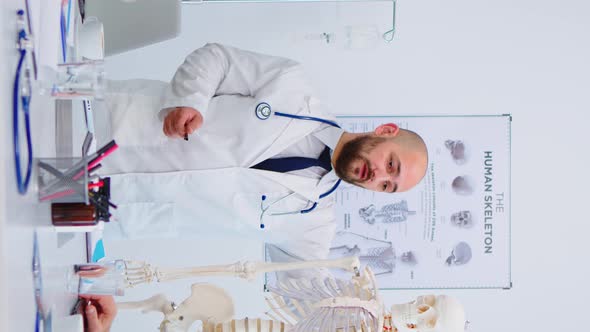 Vertical Video Medical Doctor Man Pointing on Cervical Spine of Human Skeleton