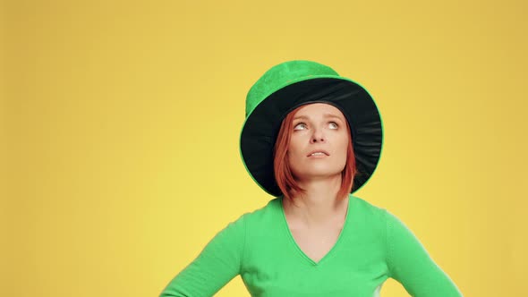 Woman with leprechaun's hat holding clover shaped banner